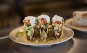 Crisp-shell beef tacos with fresh queso at Floriano's