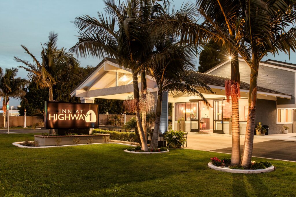 Charming hotel entrance in Lompoc, California with palm trees and outdoor signage.