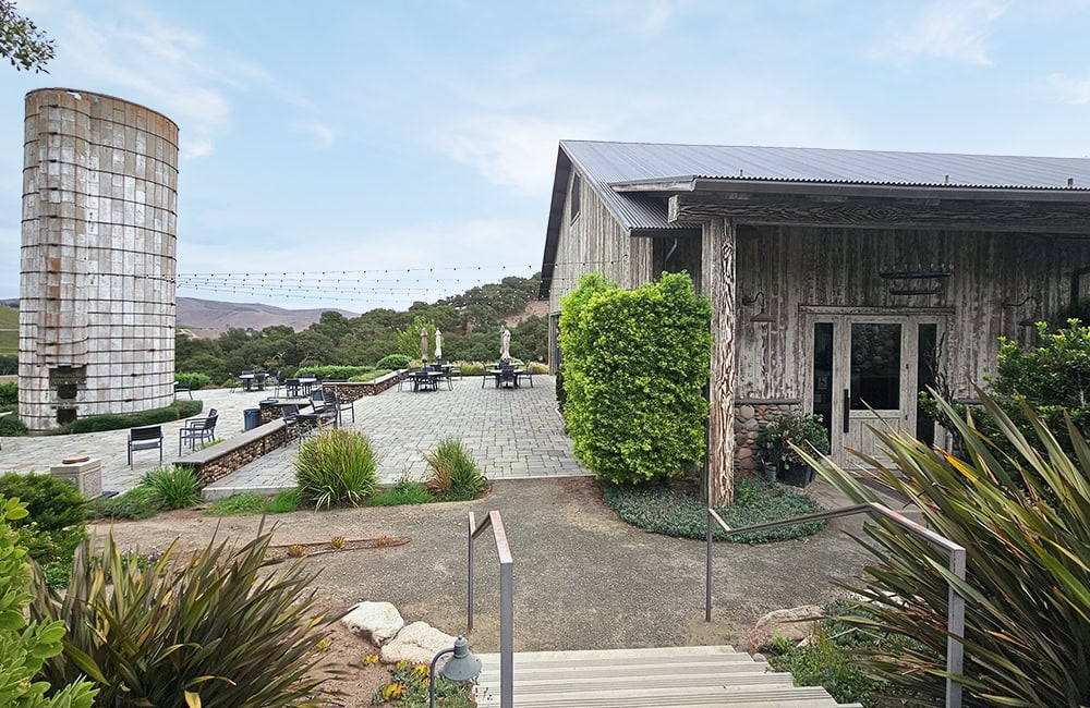 Lompoc California historic site with rustic building and lush greenery.
