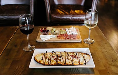 flatbread and wine on table
