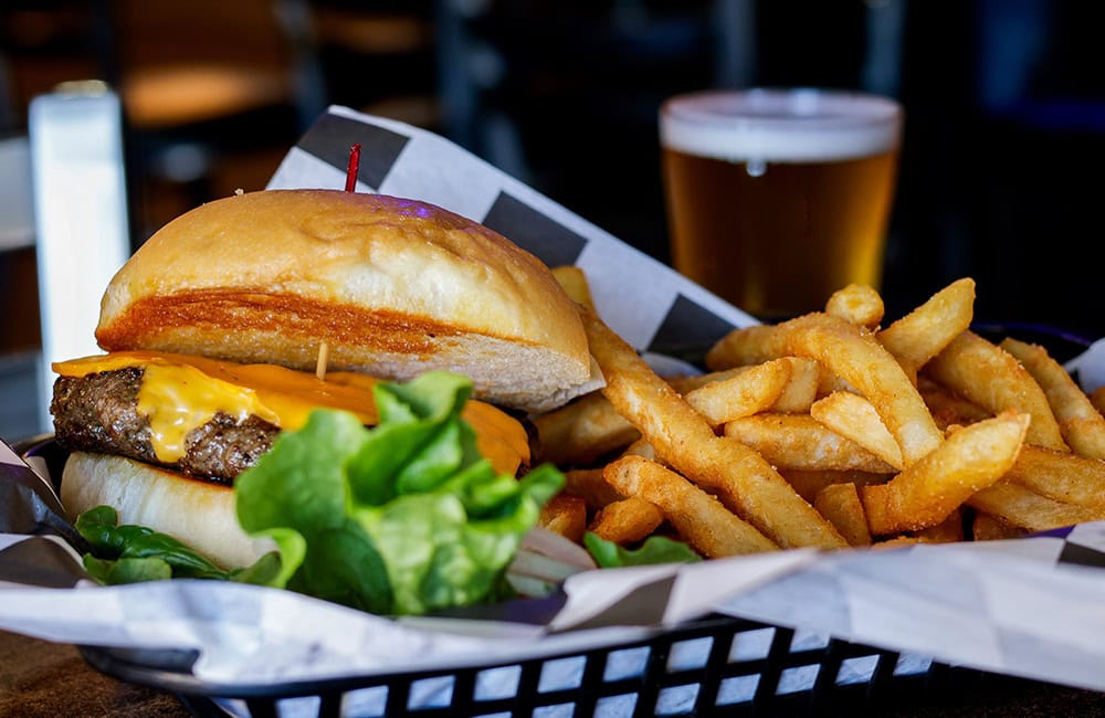 Juicy cheeseburger with fries and a glass of beer at Johnny's Bar and Grill in Lompoc.