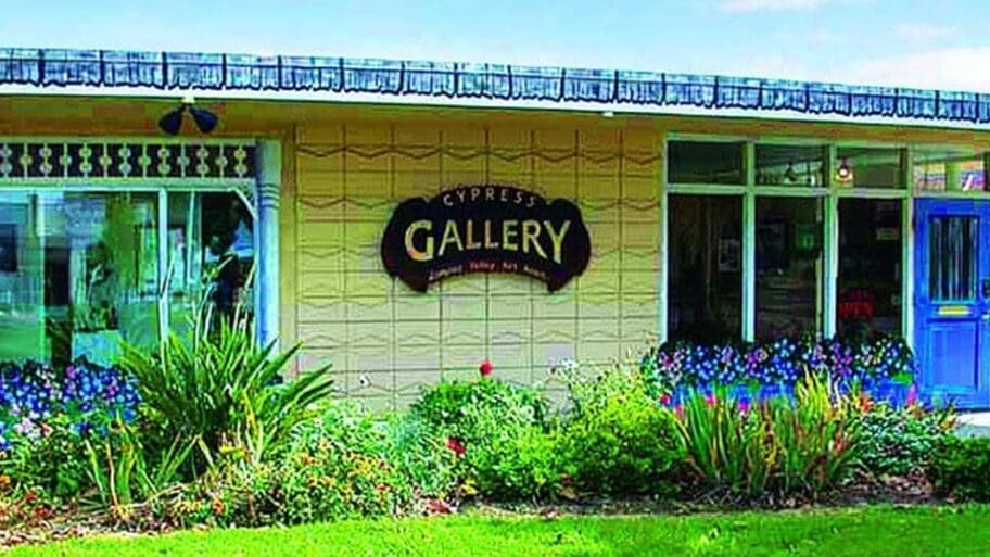 Exterior photo of the brightly blue-and-yellow painted Cypress Gallery