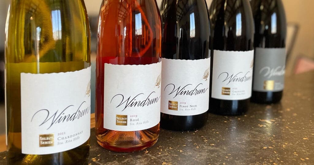 Five bottles of Windrun Wine lined up on a counter, including Chardonnay, Rosé, Pinot Noir, and two Gamay Noir, with labels facing forward.