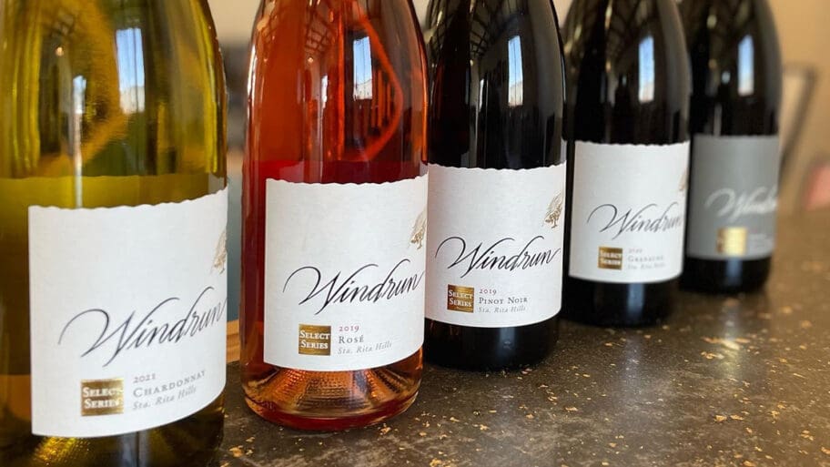 Five bottles of Windrun Wine lined up on a counter, including Chardonnay, Rosé, Pinot Noir, and two Gamay Noir, with labels facing forward.