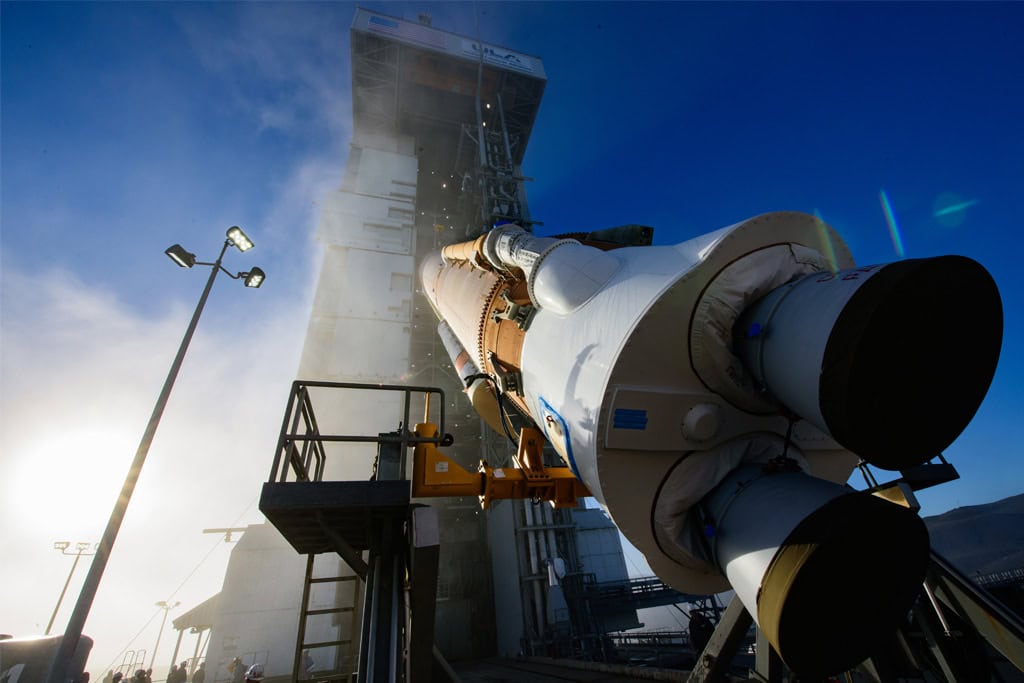 Lompoc California space launch with rocket and launch pad in clear blue sky.