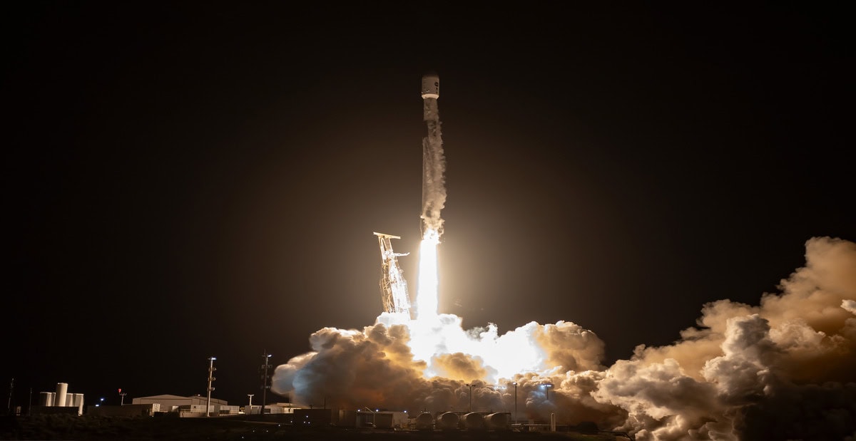 Nighttime rocket launch of Starlink satellites from Lompoc, California, during a space mission.