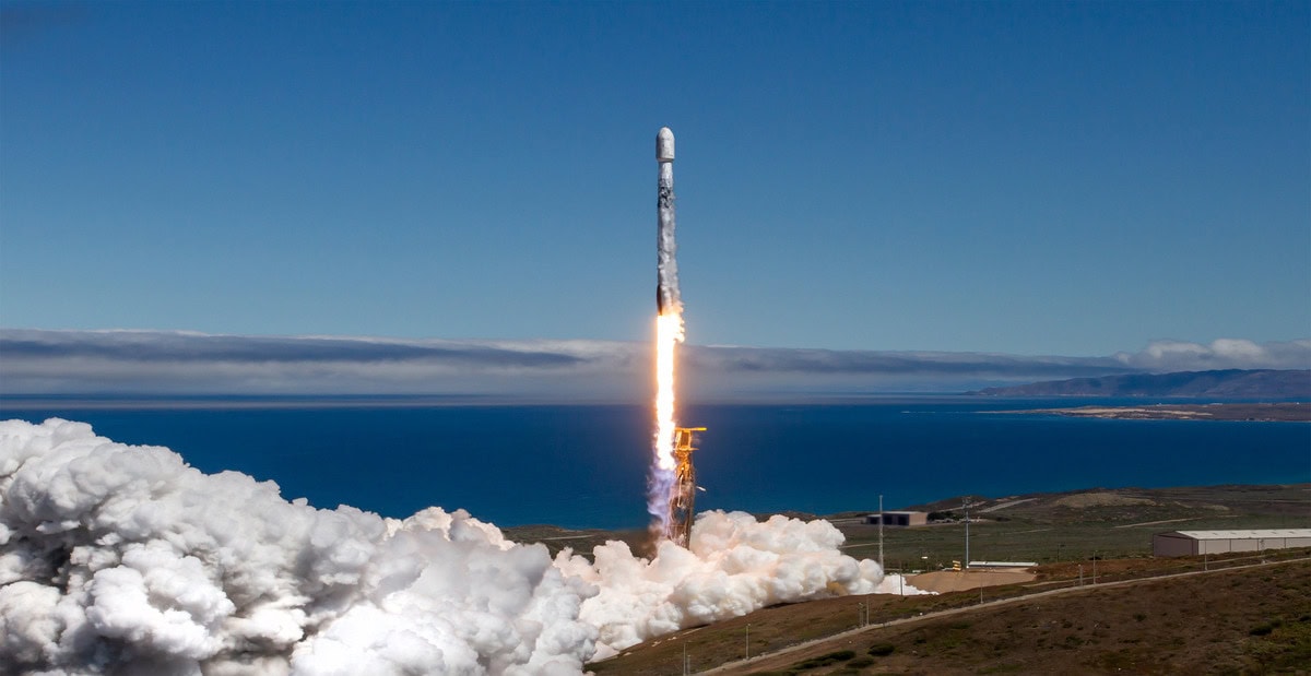 Rocket launching from Lompoc, California with ocean view in background.