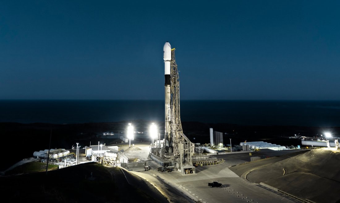 Nighttime rocket launch at Vandenberg with clear sky and launch pad in Lompoc, CA.