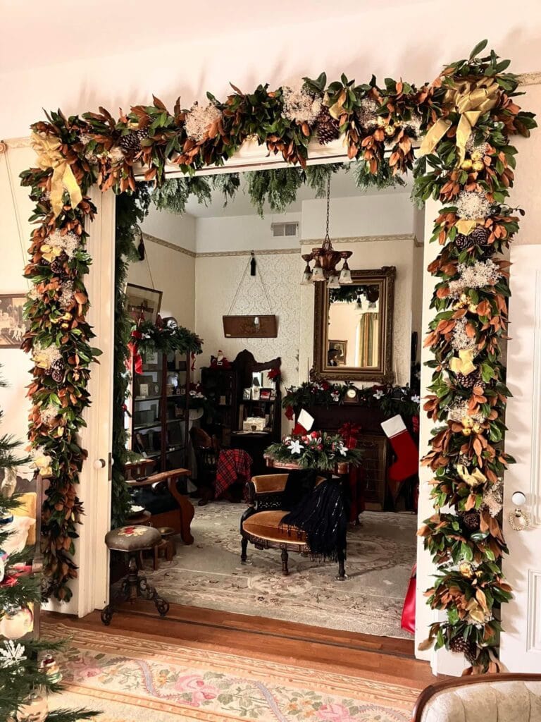 Festive Victorian 1875 Holiday Open House with floral arch and vintage furnishings.