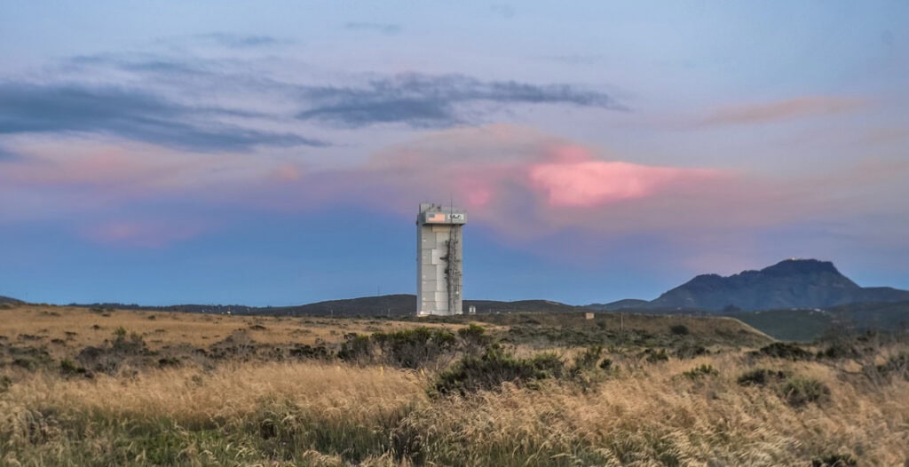 Scenic view of Lompoc California with a tall tower and mountain background.