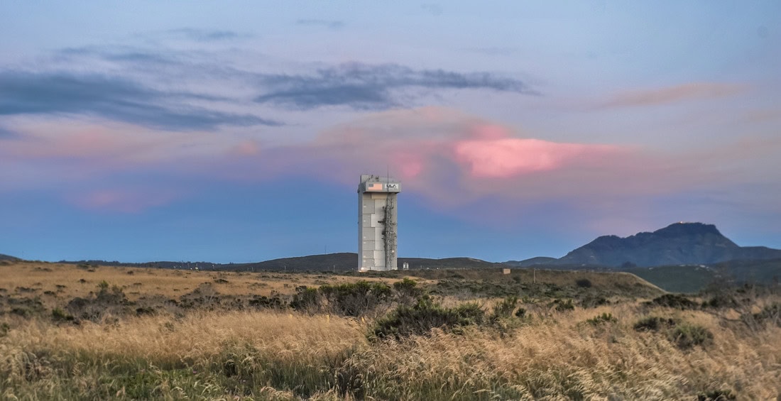 Scenic view of Lompoc California with a tall tower and mountain background.